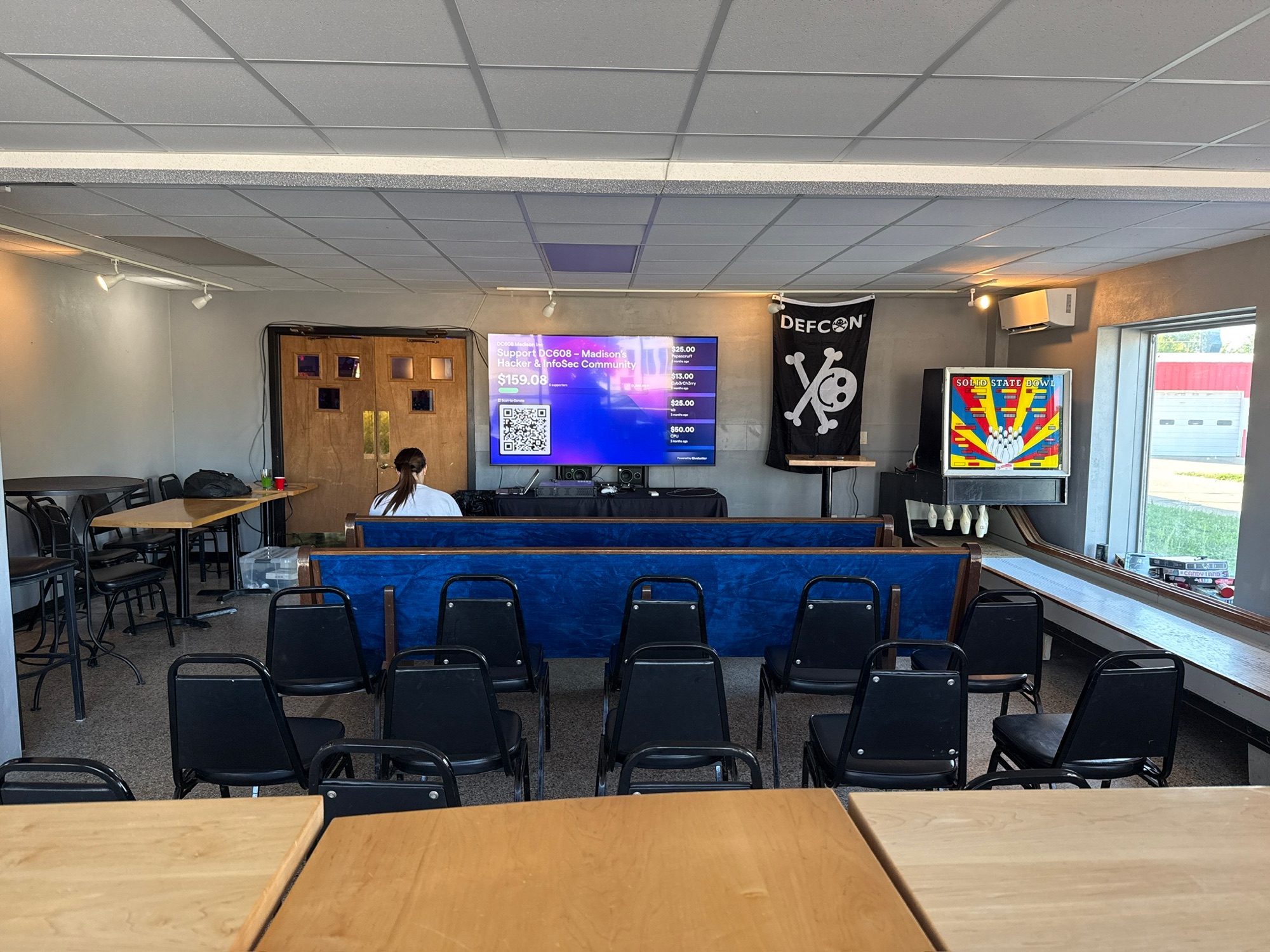 Rows of chairs facing a presentation screen in the DC608 community meeting space